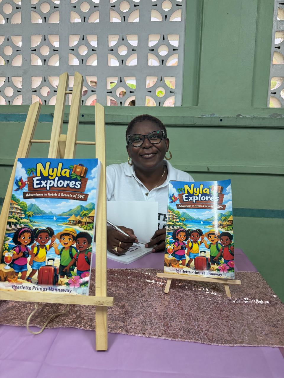 Pearlette at a book signing table with Nyla Explores