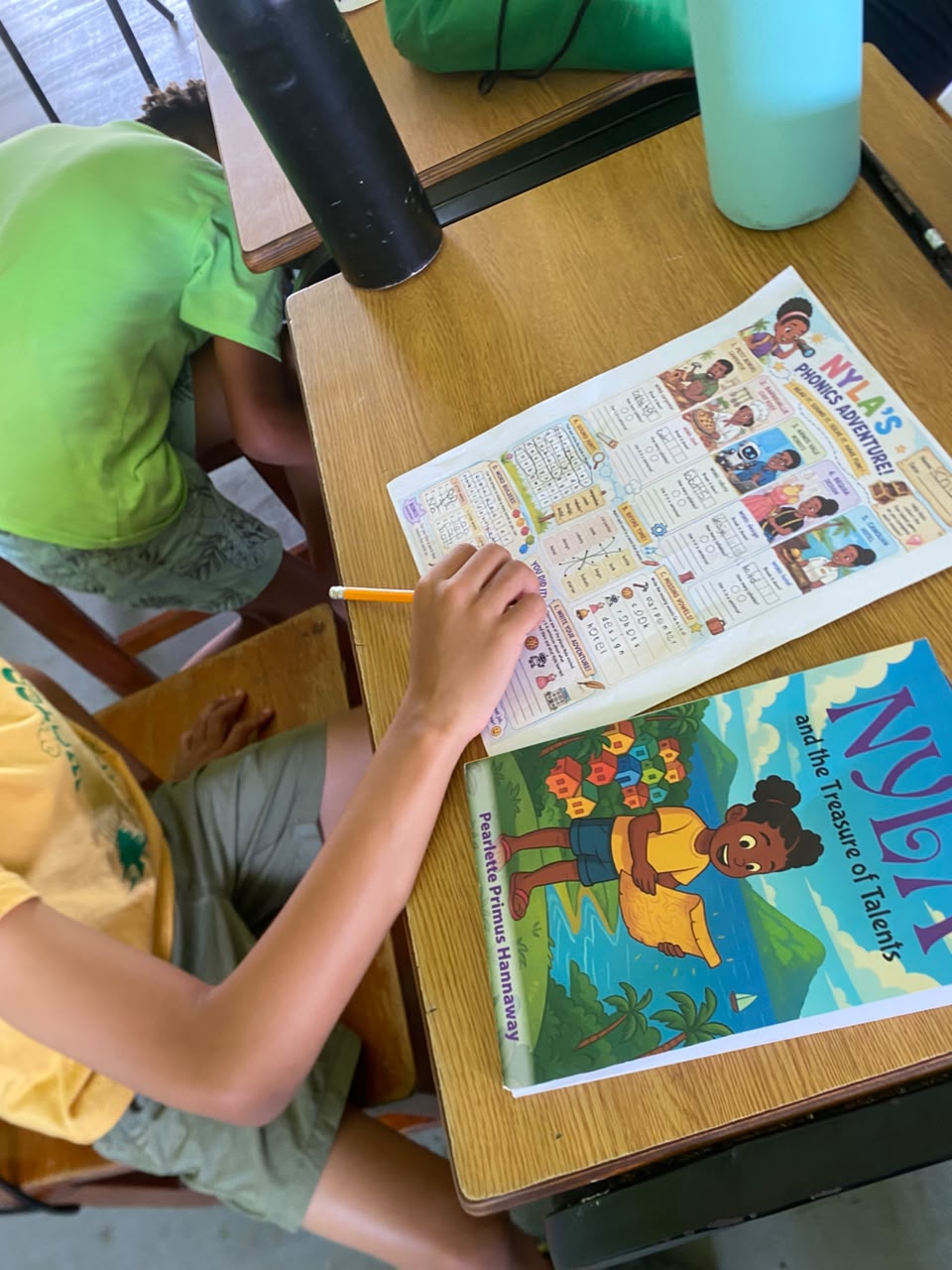 Nyla's Phonics Adventure worksheet on a school desk with a Nyla plush