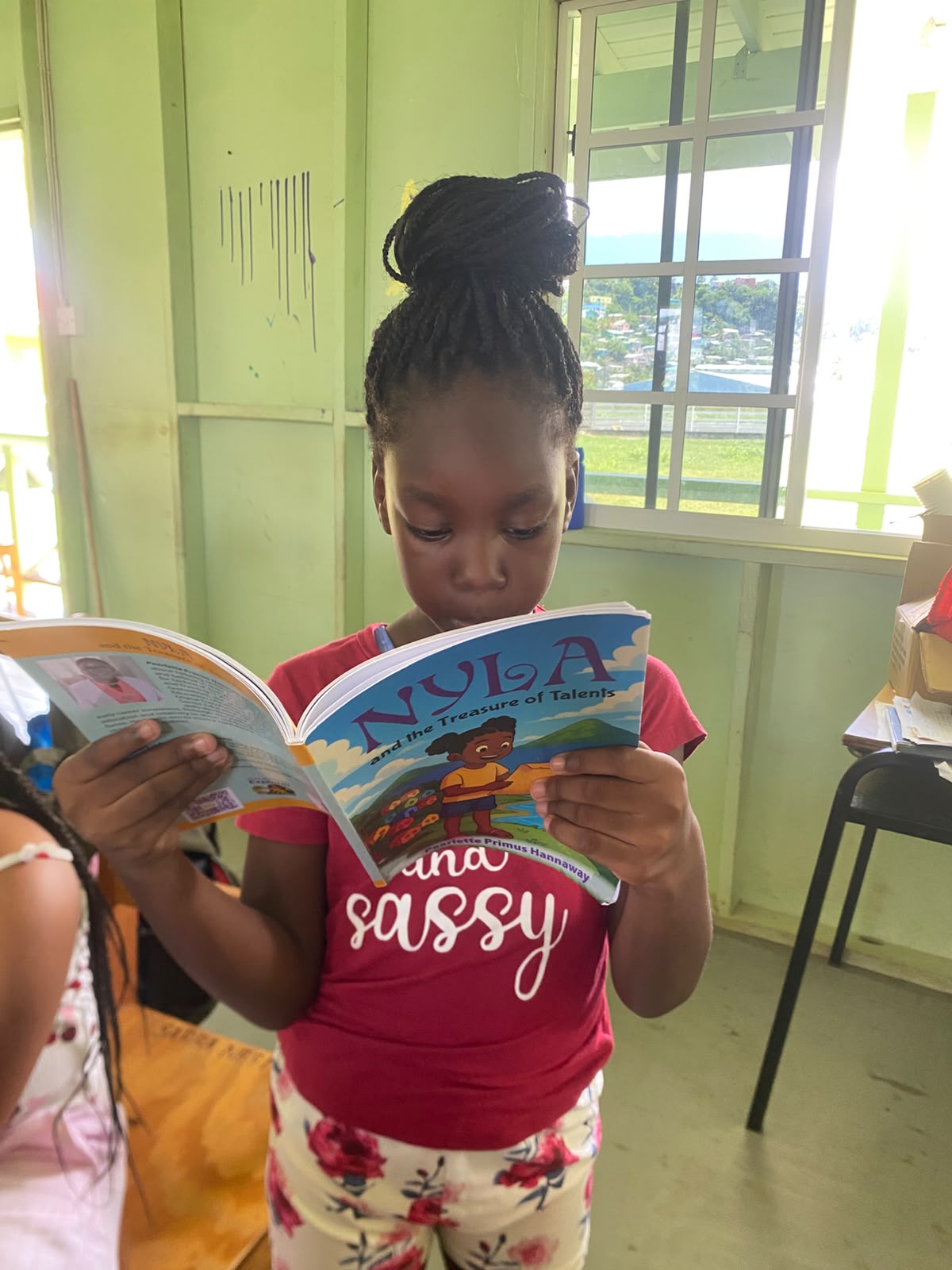 A young girl absorbed in Nyla and the Treasure of Talents